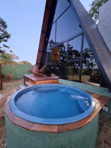 a hot tub in front of a house at Chalé da lagoa in Lagoa Santa