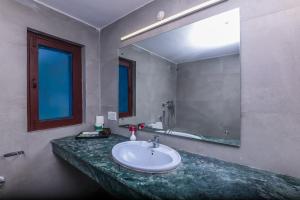 a bathroom with a sink and a large mirror at Tripp Jim Corbett A River Access Resort in Marchula +42 photos