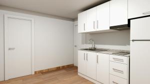 a white kitchen with white cabinets and a sink at Climia 2Sleep Apartments in Benidorm +63 photos