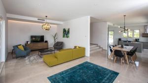 a living room with a yellow couch and a table at Villa Soderini in Dubrovnik
