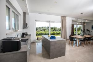 a kitchen and dining room with a table and chairs at Villa Soderini in Dubrovnik