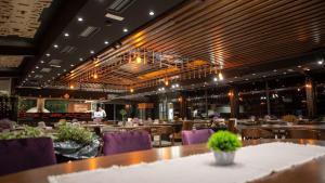 a dining room with tables and purple chairs at Aqua Spa Lux in Novi Pazar