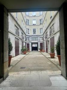 an empty hallway in a building with potted plants at Le Cocon de la Bastille - DaLoc in Grenoble