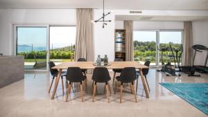 a dining room with a wooden table and chairs at Villa Soderini in Dubrovnik +27 photos
