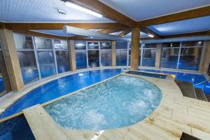 a large swimming pool in the middle of a building at Aqua Spa Lux in Novi Pazar