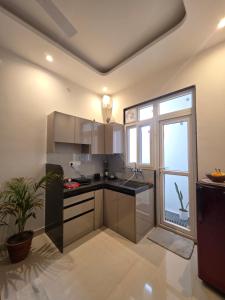 a kitchen with a counter and a large window at Yogqala Homestay 04 in Jaipur
