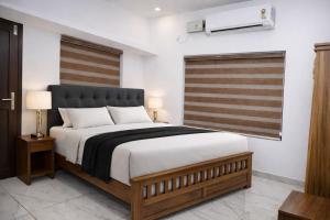 a bedroom with a large bed and a window at Nibras Villas in Varkala