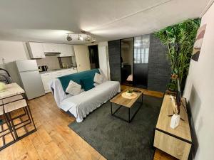 a living room with a couch and a table at Le Cocon de la Bastille - DaLoc in Grenoble