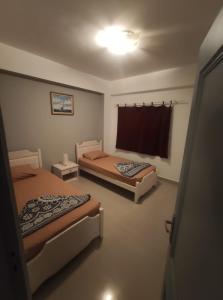 a room with two beds and a window at Sunny Dahab Resort Family Deluxe in Dahab