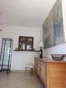 a room with a desk with a bottle of wine and a chair at La Panciotta in Azzano