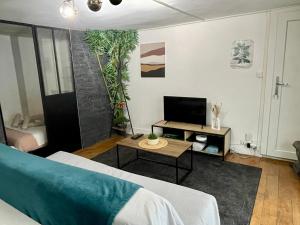 a living room with a bed and a table at Le Cocon de la Bastille - DaLoc in Grenoble
