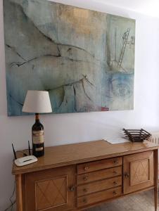 a table with a bottle of wine and a lamp at La Panciotta in Azzano