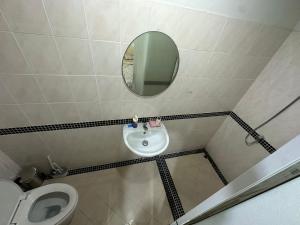 a bathroom with a sink and a mirror and a toilet at HulaFling Homestay in Ban Bo Han +17 photos