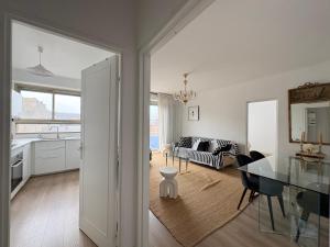 a kitchen and a living room with a table and a couch at Nuit D'or - Cape Champagne - Séjour & Pro in Épernay +13 photos