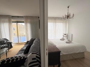 a bedroom with a bed and a chandelier at Nuit D'or - Cape Champagne - Séjour & Pro in Épernay