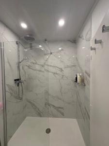 a bathroom with a shower with a glass door at Nuit D'or - Cape Champagne - Séjour & Pro in Épernay