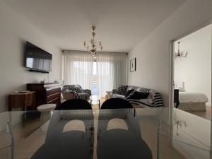 a living room with a couch and a table at Nuit D'or - Cape Champagne - Séjour & Pro in Épernay