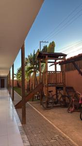 a pavilion with a bike parked next to a building at Sol, mar, equilíbrio perfeito praia do frances! in Marechal Deodoro