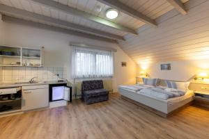 a bedroom with a bed and a desk and a chair at Pension Krone in Schwäbisch Gmünd