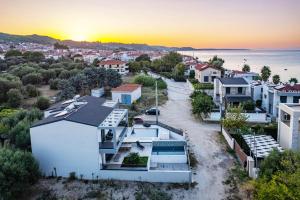 a house with a view of the ocean at LUKA VILLAS Plage in Polychrono +87 photos