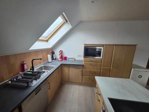 a small kitchen with a sink and a window at Lux-Bau - Stilvoll und modern in Schmelz