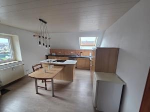 a large kitchen with a table and a table sidx sidx sidx at Lux-Bau - Stilvoll und modern in Schmelz +4 photos