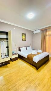 a large bedroom with a large bed and a window at HOTEL KOSHKI in Zugdidi