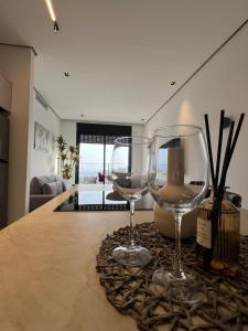 two wine glasses sitting on top of a table at Cohav Sea View in Eilat