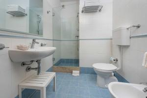 a bathroom with a sink and a toilet at Hotel Al Paradise in San Vito lo Capo +23 photos