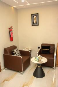 a living room with two couches and a table at KLSApartment in Lagos +1 photo