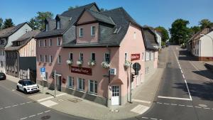 an overhead view of a street with a pink building at Hotel Gästehaus Priester in Limburg an der Lahn