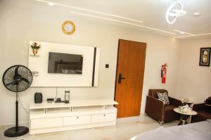 a living room with a dresser and a mirror at KLSApartment in Lagos