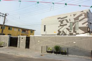 a building with graffiti on the side of it at KLSApartment in Lagos