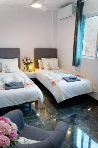 a room with two beds and a chair in it at Beach Blessing in Isla Plana