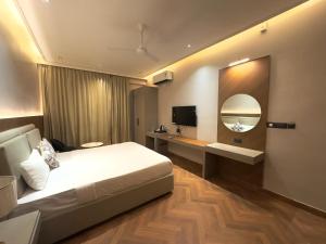 a hotel room with a bed and a mirror at Royal Palm Inn in Jāmb +70 photos