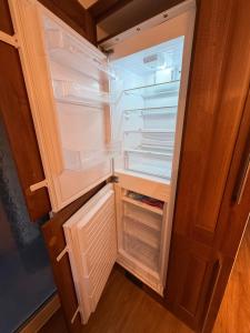 an empty refrigerator with its door open with its door open at Spacious House - Parking - Pool Table in Balderton
