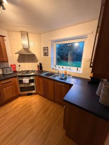 a kitchen with a sink and a window at Spacious House - Parking - Pool Table in Balderton +38 photos