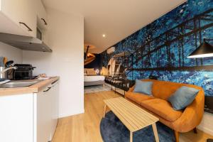 a living room with a couch and a kitchen at Air Nomad • Sydney in Valenciennes +11 photos