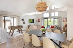 a living room with a ping pong table and a living room at Hill View House - Cookswood in Holcombe