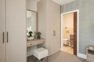 a bathroom with a sink and a toilet and a mirror at Hill View House - Cookswood in Holcombe +28 photos