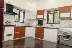 a kitchen with a washer and a washing machine at Well maintained Calm atmosphere in Putuppalli