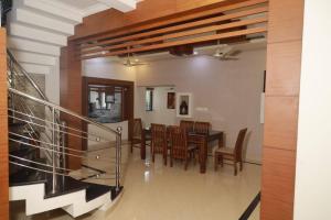 a dining room with a table and chairs at Well maintained Calm atmosphere in Putuppalli