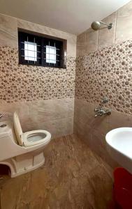 a bathroom with a toilet and a sink at Well maintained Calm atmosphere in Putuppalli +13 photos