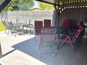 a group of chairs and tables on a patio at FeWo Igelnest ID 16292-0 in Kargow