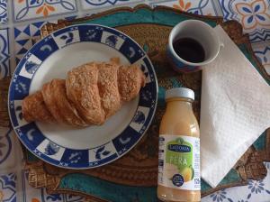 a plate of pastries and a bottle of coffee on a table at Affittacamere Piagge in Orvieto