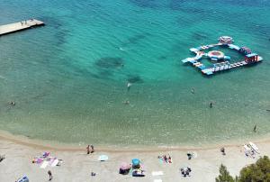 an aerial view of a beach with a boat in the water at hotel depandance Imperial Green by GLOBTOUR in Vodice
