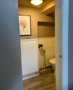 a bathroom with a toilet and a picture of a flower at Kiladalens Golf & Lodge in Nyköping +58 photos