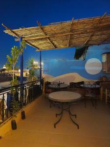 a patio with a table and chairs on a deck at Terrace House in Marrakesh