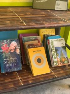 a shelf with a bunch of books on it at Pakse Chill Hostel in Pakse