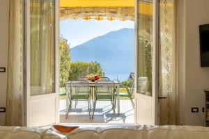 a glass door leading to a patio with a table at Apartment Maya - Tremezzina in Tremezzo